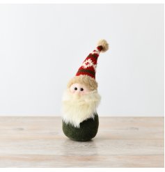 An endearing little gonk with traditional and festive red and green decoration.