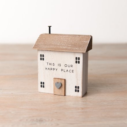 A rustic painted house with miniature heart detail and happy place slogan. 