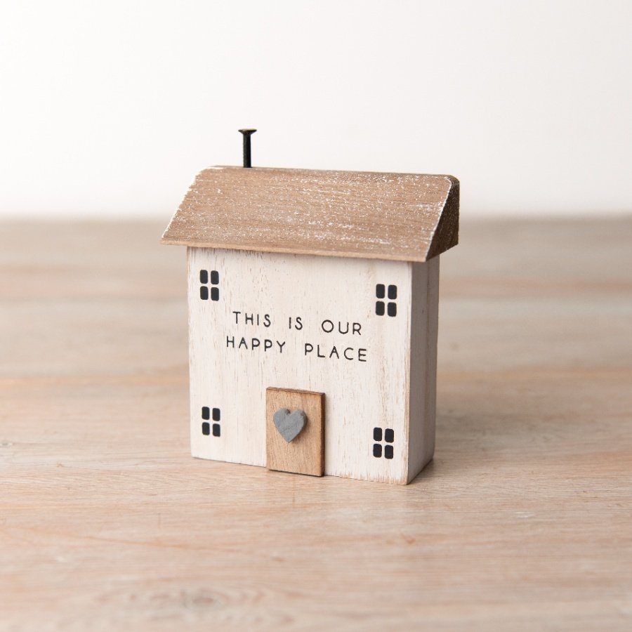 This is our happy place. A rustic wooden house ornament with a distressed painted finish and 3D details.