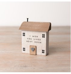 A rustic wooden house decoration with a distressed painterly finish and charming sentiment slogan. 