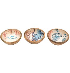 Three mango wood bowls featuring a captivating ocean-themed print intricately enameled at the center.