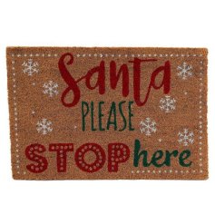 A festive door mat with a fun Santa please stop here motif