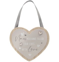 Hung from a grey ribbon, a sentimental heart shaped plaque, quoting 'Nan, you filled our lives with love'.