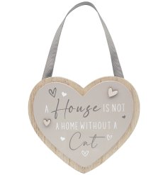A shabby chic wooden plaque in the shape of a heart with loving text towards a cat. 