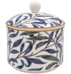 A Willow Bough sugar bowl adorned with an intricate design of blue and green leaf prints. 