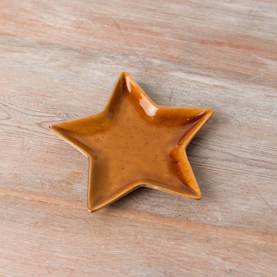 An elegant ceramic dish, in an assortment of 2 designs, shaped like a star, featuring a stunning burnt orange hue