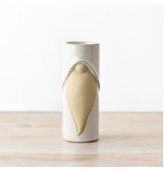 A tall ceramic tea light holder with a reactive glaze finish, showcasing gonk details, and featuring a natural-looking b
