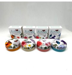 A fragranced lip balm in a circular tin featuring illustrations of butterflies and flowers.