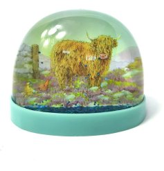 A colourful blue snow globe featuring an image of a highland cow, part of the the Jan Pashley range.