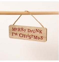 A humorous wooden sign with the words "Merry Drunk, I'm Christmas" In a dark red distorted font. 