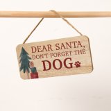 A wooden sign with the saying "Dear Santa, don't forget the dog"