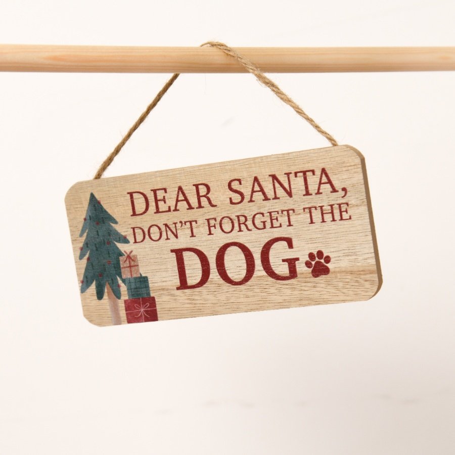 A wooden plaque displaying the message "Dear Santa, remember the dog,