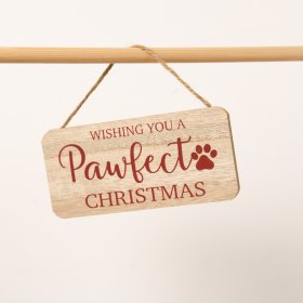 A charming wooden sign featuring the phrase "Wishing you a pawfect Christmas" in a deep red font