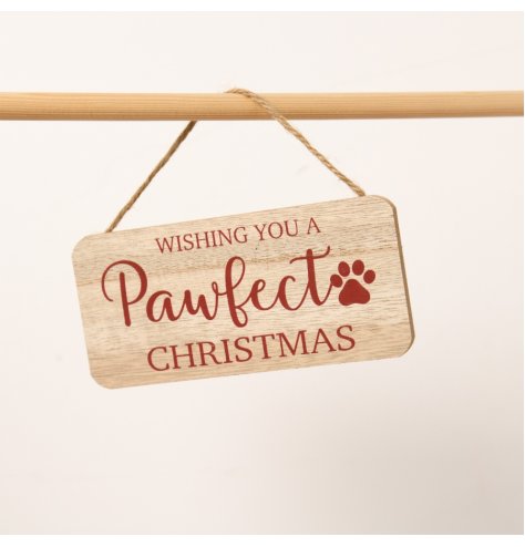 A charming wooden sign featuring the phrase "Wishing you a pawfect Christmas"