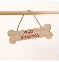 A lovely wooden hanger in the shape of a bone featuring the words 'Merry Woofmas' 