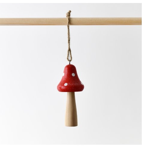 A wooden mushroom in red, featuring a jute hanger and adorned with a frosted glitter coating. 