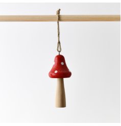 A wooden mushroom in red, equipped with a jute hanger and a finish of frosted glitter.