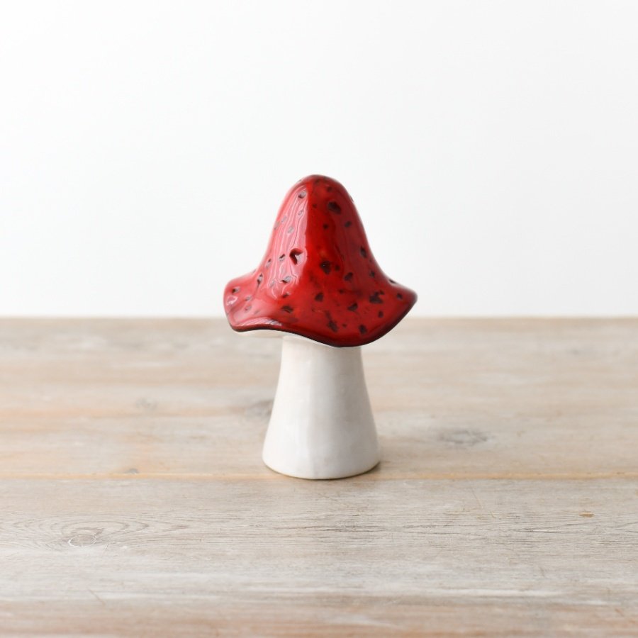A vibrant and enchanting red mushroom made from ceramic. Sure to add a magical touch to any space.