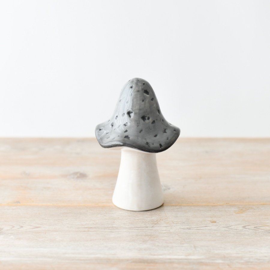 A ceramic mushroom in grey and white.
