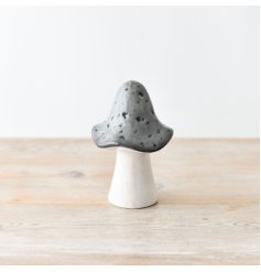 A grey and white ceramic decorative mushroom.