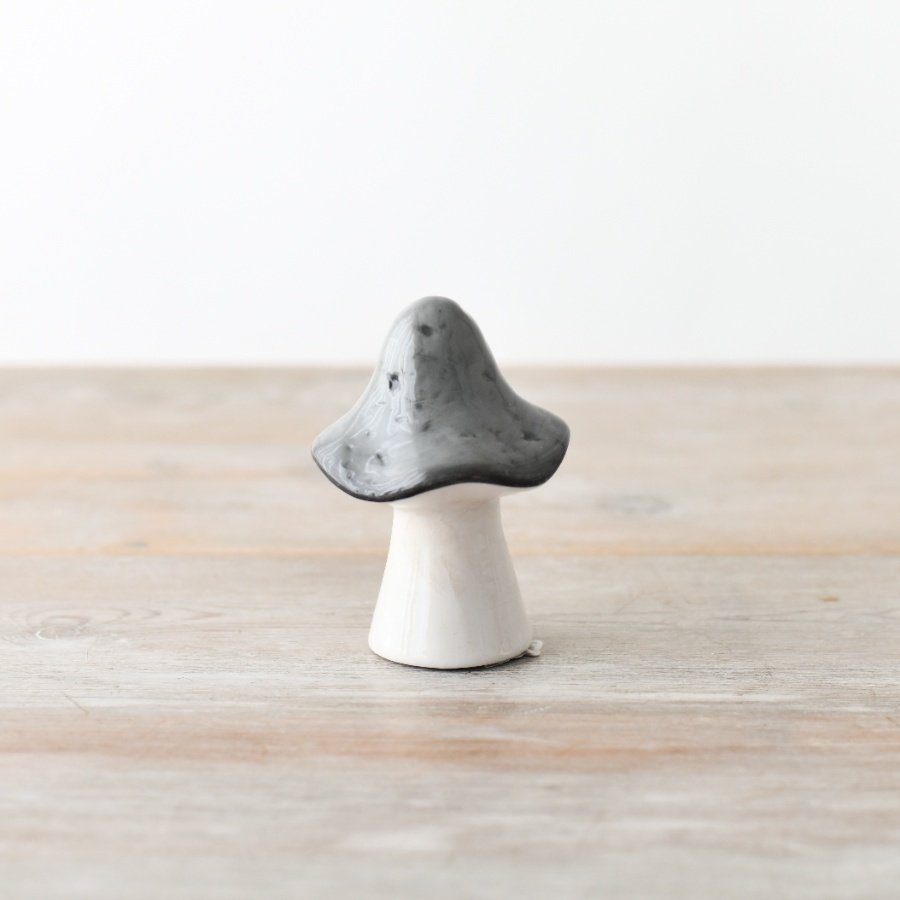 A small glazed ceramic mushroom in grey 