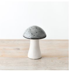 A whimsical ceramic mushroom with a grey glazed top.
