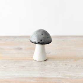 A delightful and whimsical ceramic mushroom with a glazed grey top.