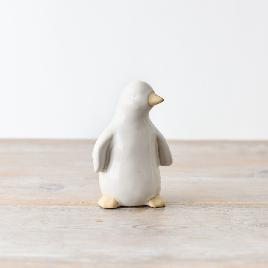 A stylish ceramic penguin ornament, featuring a captivating reactive glaze finish 