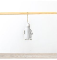 A charming ceramic penguin hanger, certain to bring a sense of winter wonderland enchantment to any festive decoration.