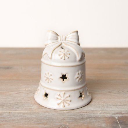 An exquisite festive LED bell in a beautiful white reactive glaze adorned with snow decals and star-shaped cutouts.