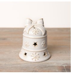 An enchanting festive LED bell in a stunning white reactive glaze adorned with snow decals and star cutouts.