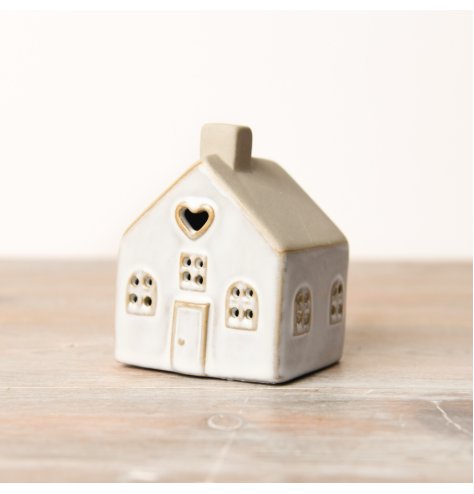 A delicate LED house adorned with embossed windows, doors, and a charming heart, allowing light to gently beam through.