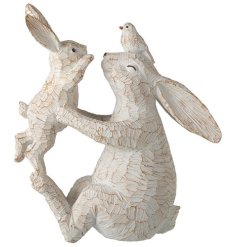 A charming mother and baby rabbit ornament with a rough textured and natural finish.