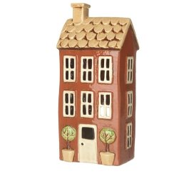 A rustic t- light holder in the shape of a house. 
