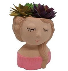 A succulent planter in the shape of a females head. 