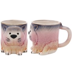 A pink and blue ceramic mug in the shape of a sitting cat.