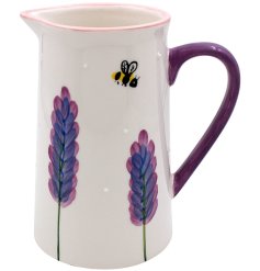 A floral jug with a violet handle finished with a simple glaze.