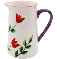 A decorative jug adorned with paintings of tulips finished with a simple glaze.