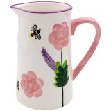 A floral patterned ceramic jug displaying roses and bees.