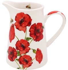 A white jug adorned with detailed painted Poppies and bees. 