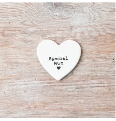 A small porcelain heart token inscribed with the phrase "Special Mum."