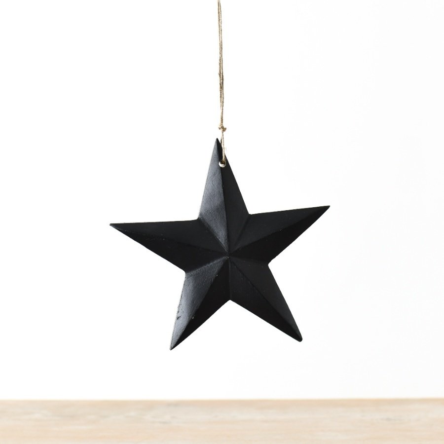 An elegant star-shaped hanger boasting a matte black finish and suspended by a jute string.