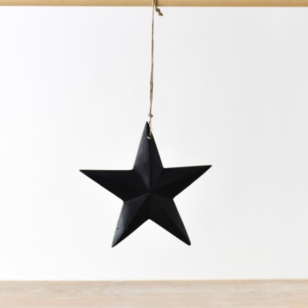 A chic wooden star hanging ornament with a matt black finish and just string hanger.