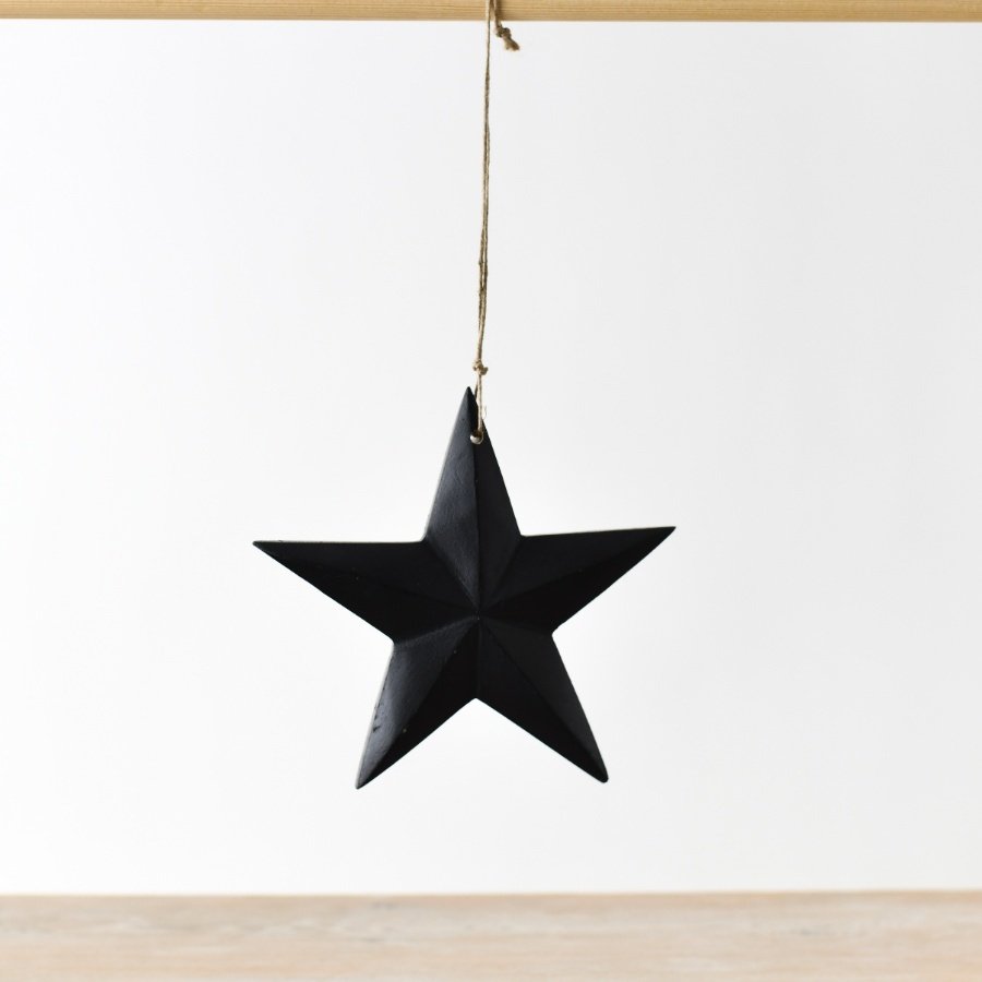 An elegant hanging ornament crafted from wood, showcasing a sophisticated matte black finish.