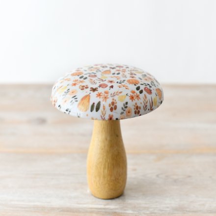 A stylish wooden mushroom featuring a beautiful glazed top adorned with a captivating autumnal pattern.