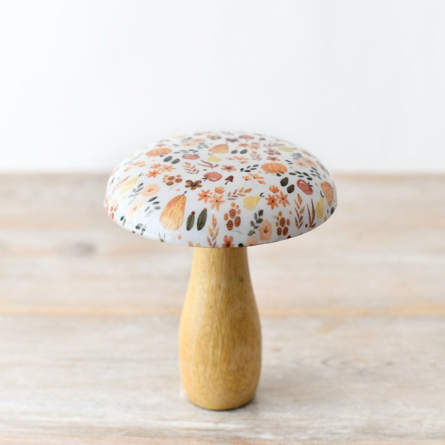 A stylish and chic wooden mushroom featuring a stunning glazed top adorned with gorgeous a autumnal pattern