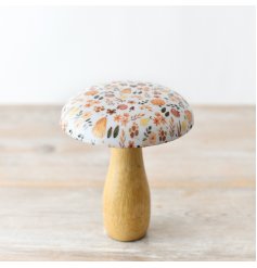 A stylish wooden mushroom featuring a beautiful glazed top adorned with a captivating autumnal pattern.