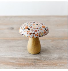 An enchanting mango wood mushroom adorned with a glazed top and autumnal pattern.