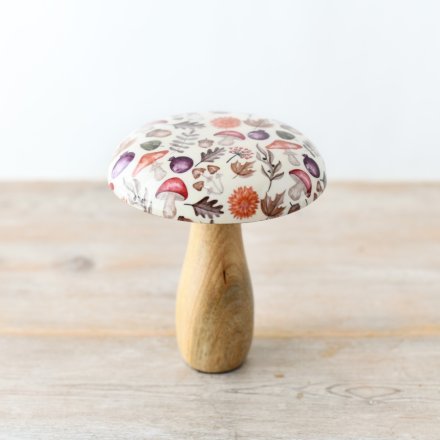 A charming mushroom crafted from mango wood, featuring a glazed top and adorned with an autumnal pattern.