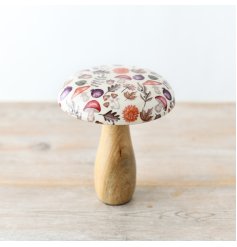 A charming mushroom crafted from mango wood, featuring a glazed top and adorned with an autumnal pattern.